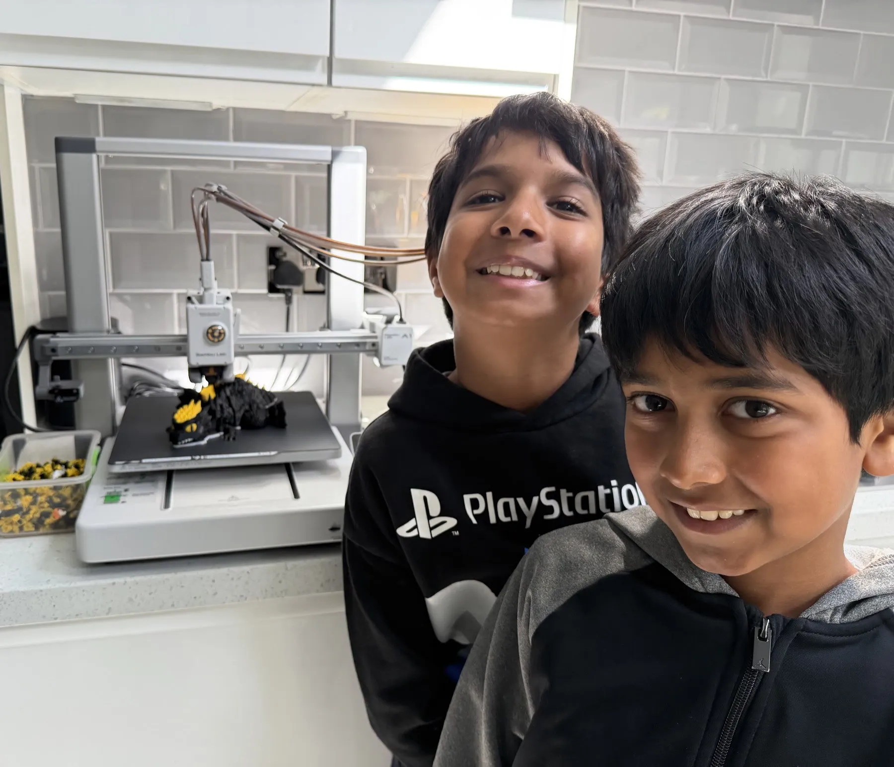 The two young makers behind 3D Kumars with their Bambu Lab 3D printer